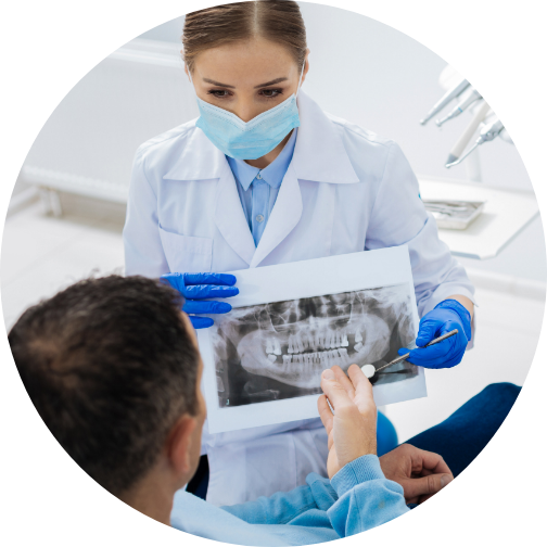 dentist shows xrays to patient